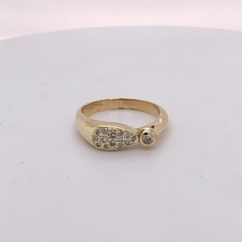 18 karat yellow gold pave diamond ring with 1 bezel set diamond.