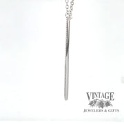 Side view of 14 karat white gold diamond bar pendant