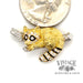 Tiffany & Co. vintage Raccoon 18 karat yellow gold and platinum diamond pin, shown next to a quarter for size reference