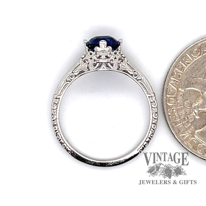 14 karat white gold 1.15ct natural blue sapphire filigree solitaire ring, side view through ring, shown with quarter for size reference