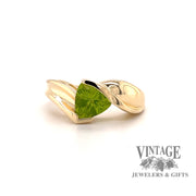 14 karat yellow gold trillion shaped peridot bypass style ring