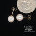 8.5 mm Akoya pearl 14ky gold stud earrings quarter for scale