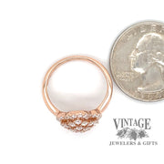 18 karat rose gold .75 ct. total weight diamond cluster ring, shown with quarter for size reference