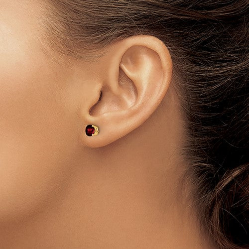14 karat yellow gold 5 mm round natural Garnet stud earrings on model