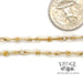 18 karat yellow gold 19" elongated knot link chain, shown with quarter for size reference