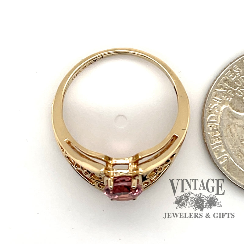 10 karat yellow gold 1.16ct Pink tourmaline filigree ring, side view through finger, shown next to quarter for size reference