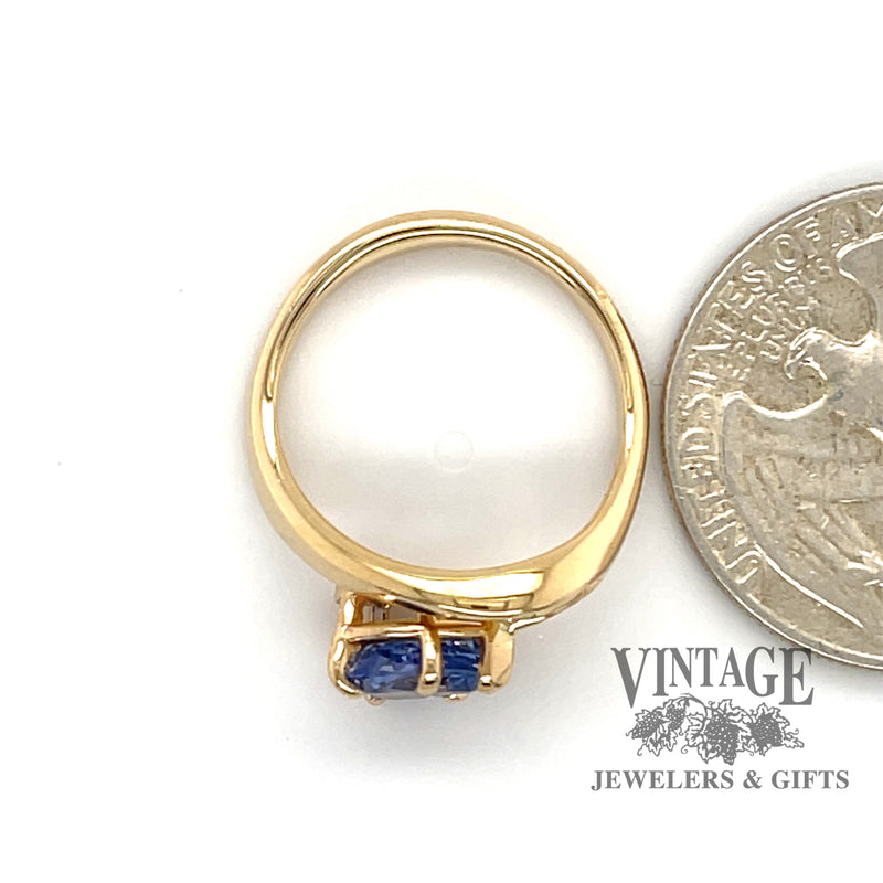 1.30ct Pear shape blue sapphire contemporary 14ky ring next to quarter for scale