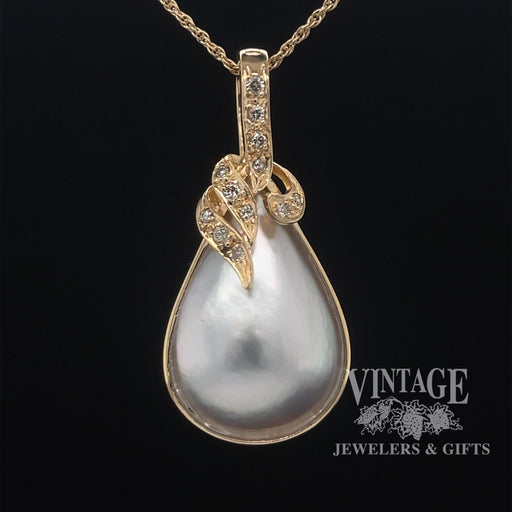 Mabe' pearl and diamond 14ky gold pendant.
