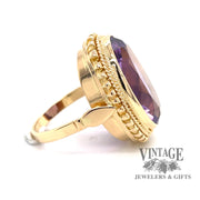 Oval bezel set amethyst 18ky gold ring side