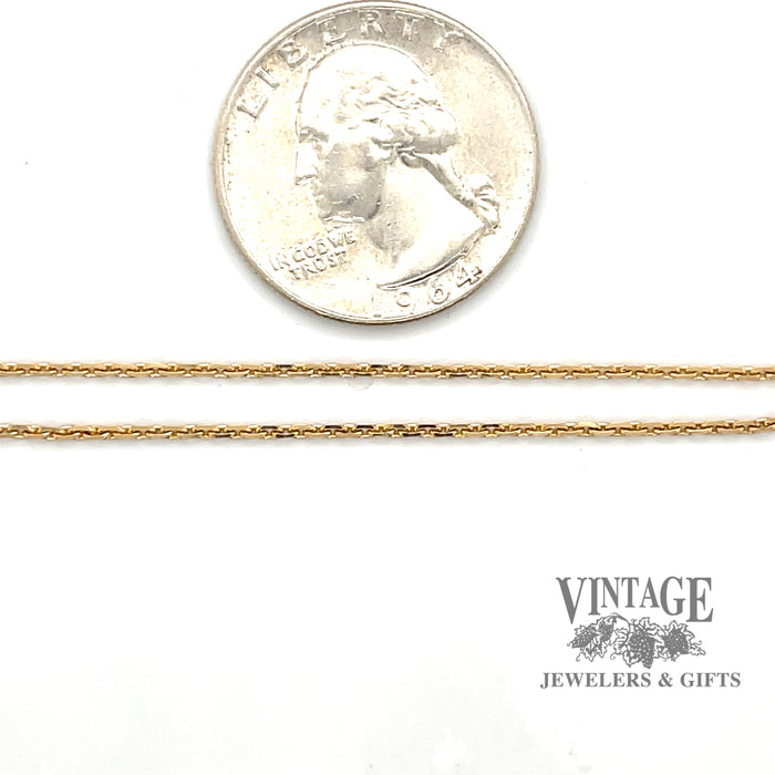 1.3 mm 14ky gold 30" cable chain next to quarter for perspective