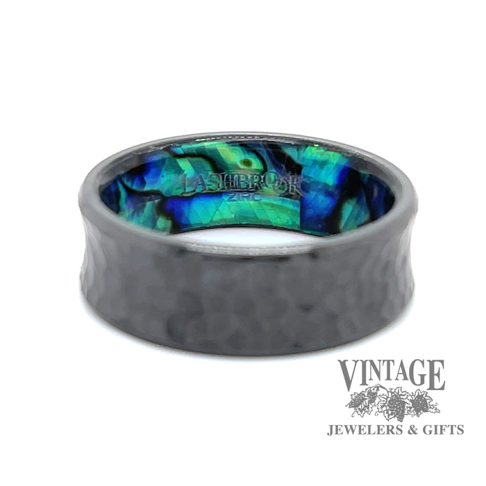 Hammered black zirconium band ring surrounds an inner sleeve of blue green abalone.