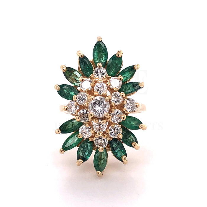 14 karat yellow gold marquise emerald cluster ring with round brilliant cut diamonds.