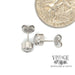 .48 CTW diamond bezel 14kw gold stud earrings next to quarter for scale