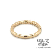 Rear view of 14 karat yellow gold band with alternating round brilliant diamonds and emeralds