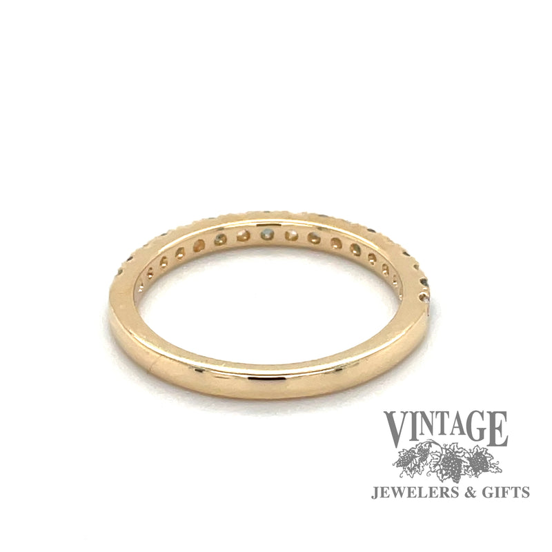 Rear view of 14 karat yellow gold band with alternating round brilliant diamonds and emeralds