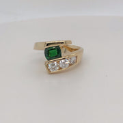 14 karat yellow gold .80ct Tsavorite and diamond channel set bypass ring