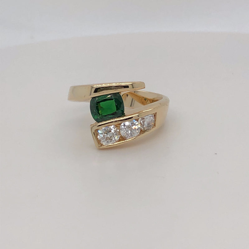 14 karat yellow gold .80ct Tsavorite and diamond channel set bypass ring