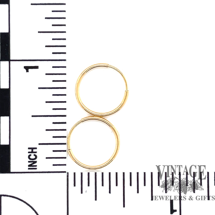 14 karat yellow gold mini endless hoop earrings, shown with ruler for measurements
