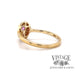 14 karat yellow gold oval pink sapphire and diamond halo ring, angled side view
