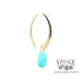 14 karat yellow gold sweep earrings with faceted turquoise drops, side view