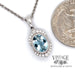 14 karat white gold aquamarine and diamond 18" necklace, shown with quarter for size reference